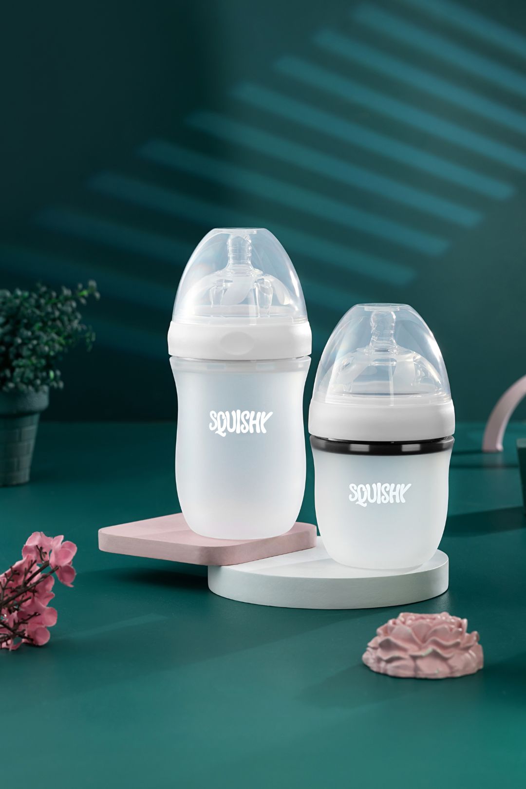 baby bottle product photography green background studio shot