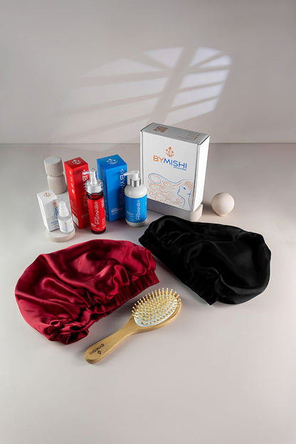 cosmetics group shot of bottles and hair cap grey background