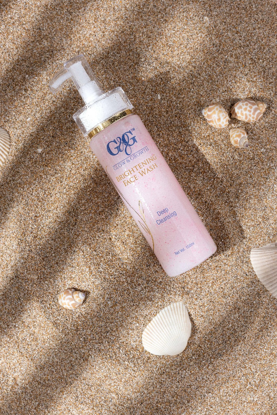 face wash bottle photography on beige sand