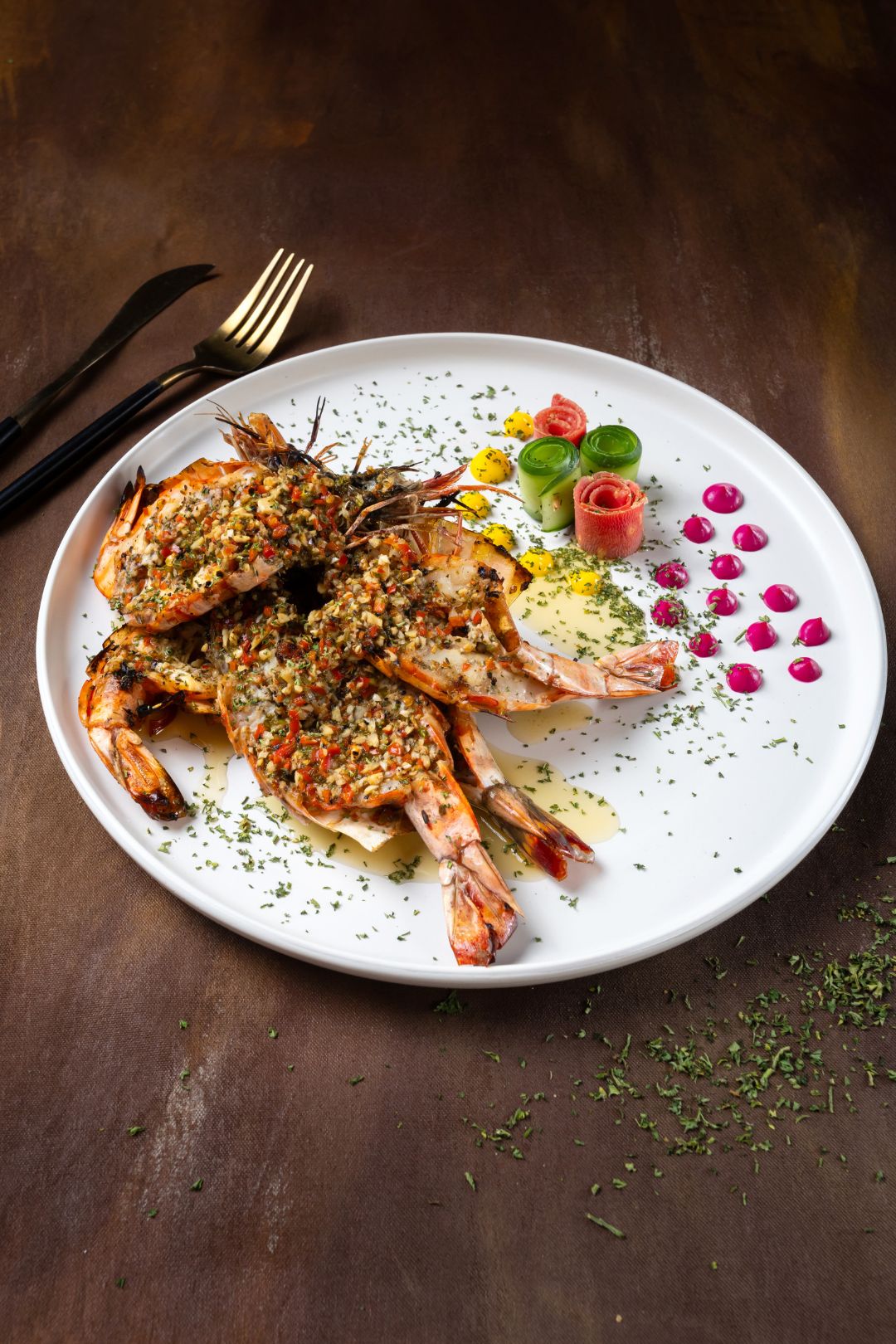 food photography of plated dish of grilled prawns with garnishes on a wooden surface