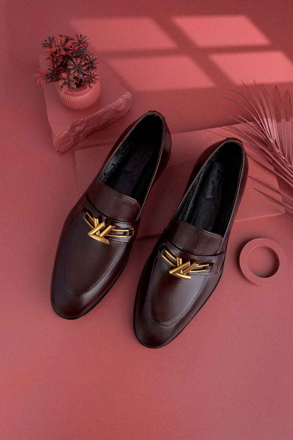 formal dark brown shoes creative studio shot on a pink background