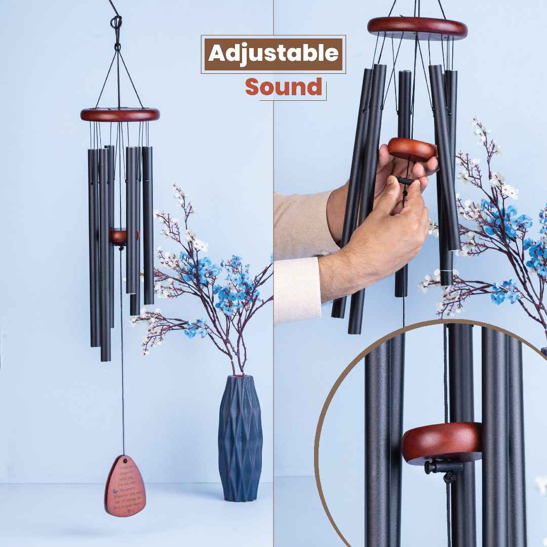 Wind chime with adjustable sound feature, held by a hand against a light blue background.